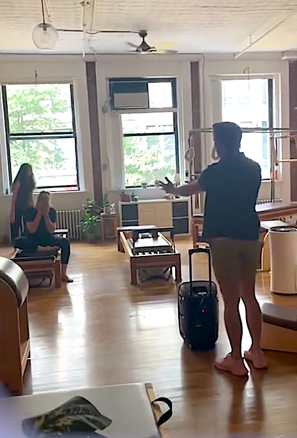 man singing to someone in a pilates class