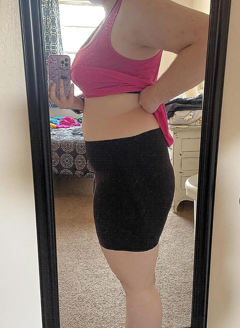 reviewer selfie in mirror while wearing bike shorts in black