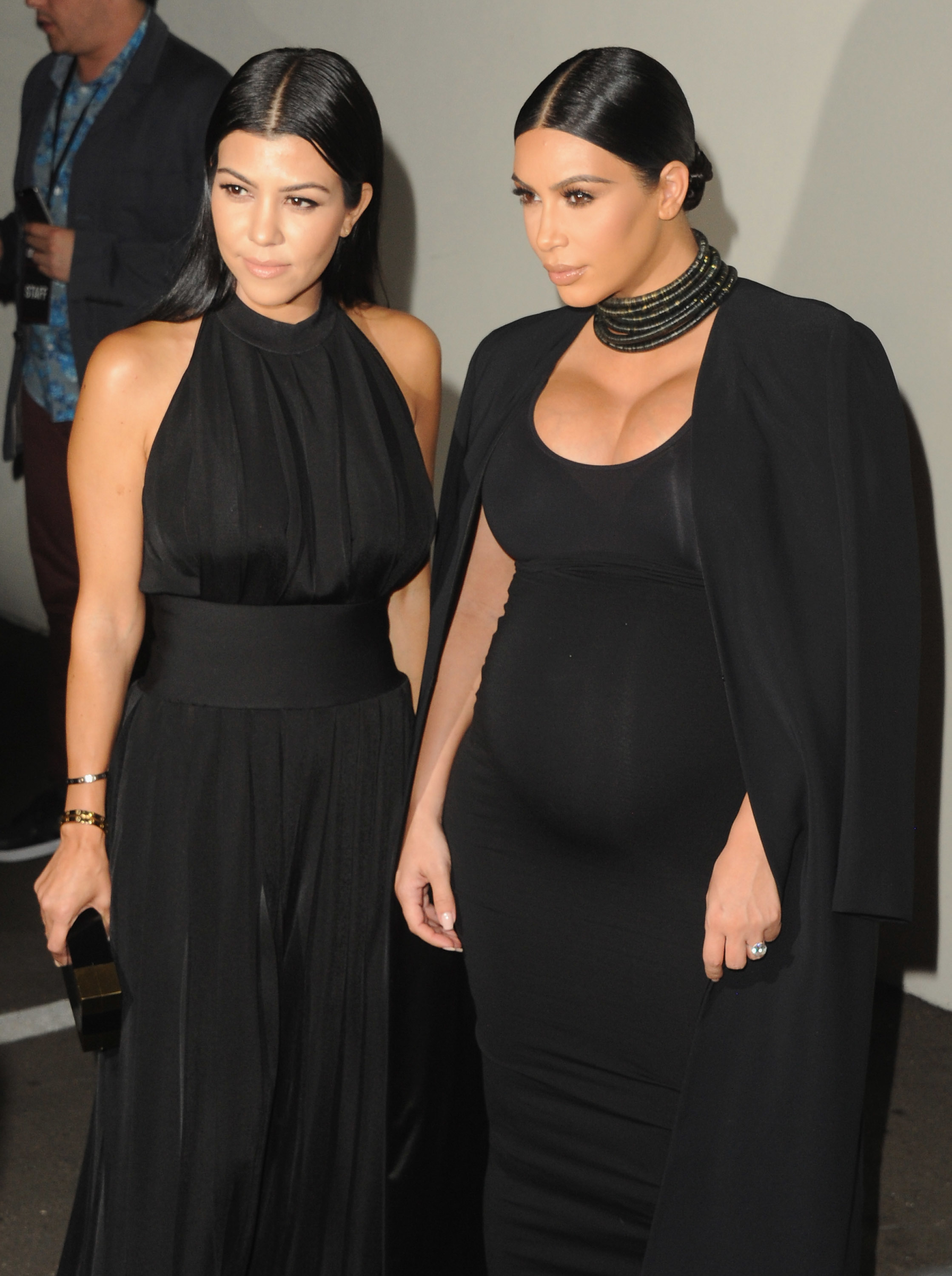 Close-up of Kourtney and Kim Kardashian at a media event