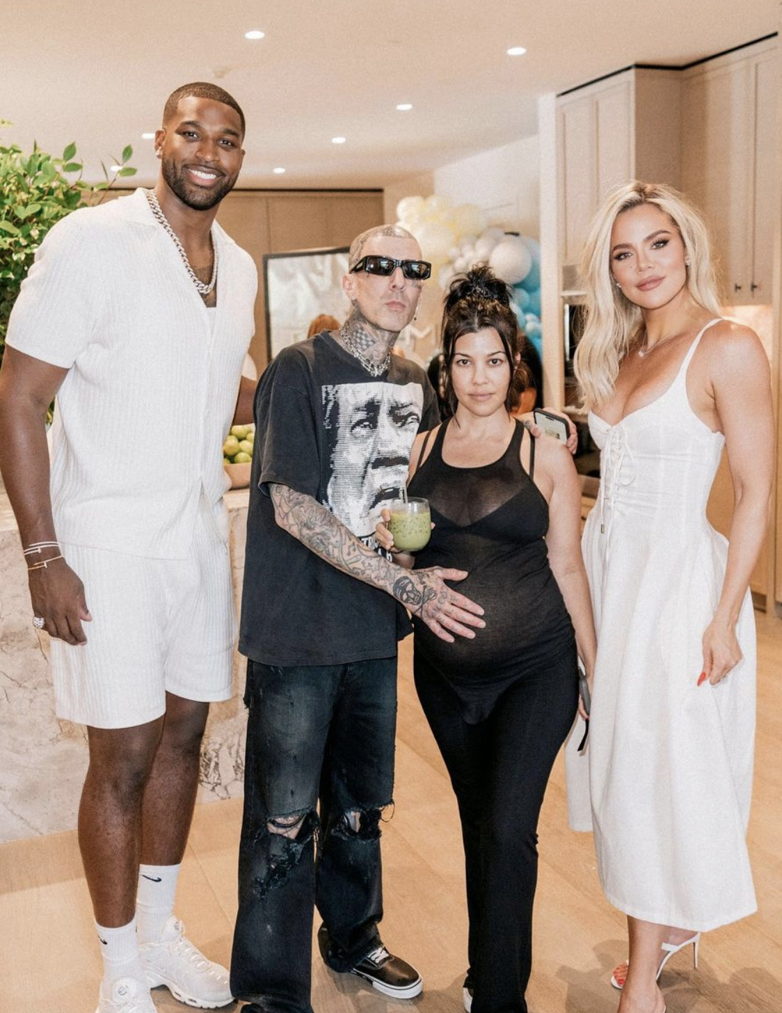 Tristan Thompson, Travis, Kourtney, and Khloé standing together