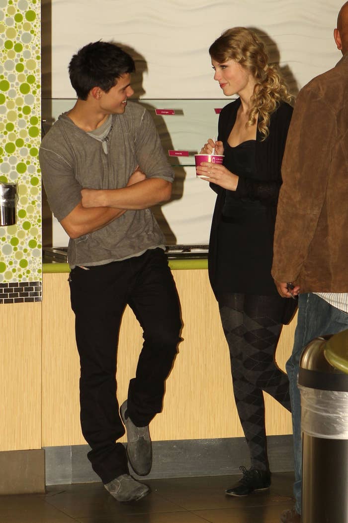 Taylor Lautner smiling at Taylor Swift as she eats ice cream