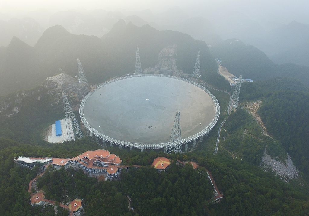 A wide sphere rising above a hilltop