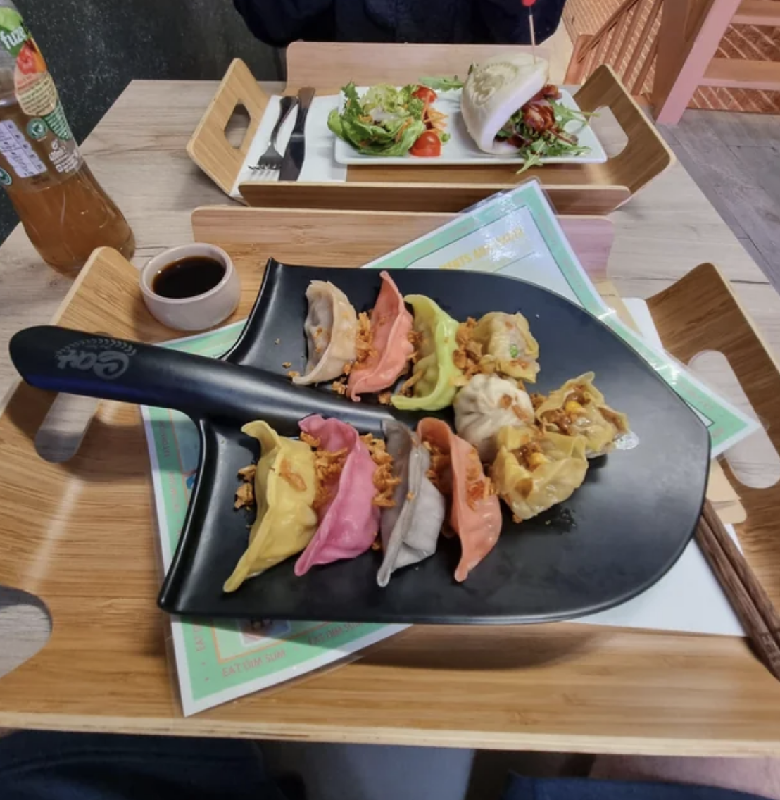 A shovel with different-colored dumplings on it
