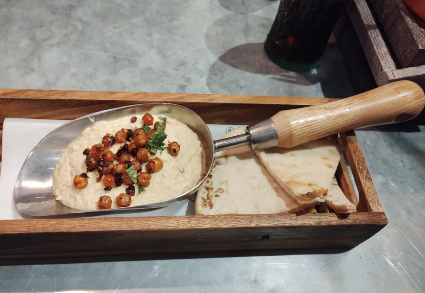 Hummus on a small gardening shovel