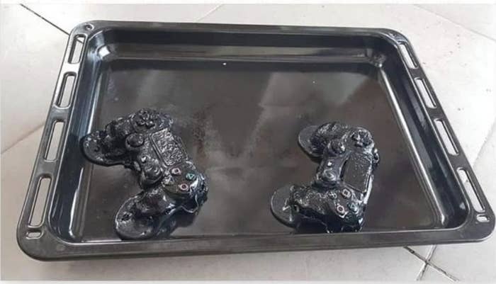 A duo of PlayStation controllers on an oven pan completely melted