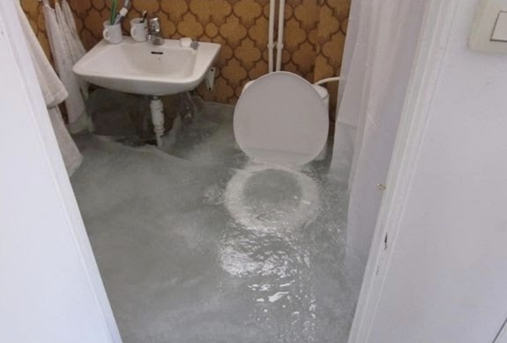 A bathroom filled with a few feet of ice