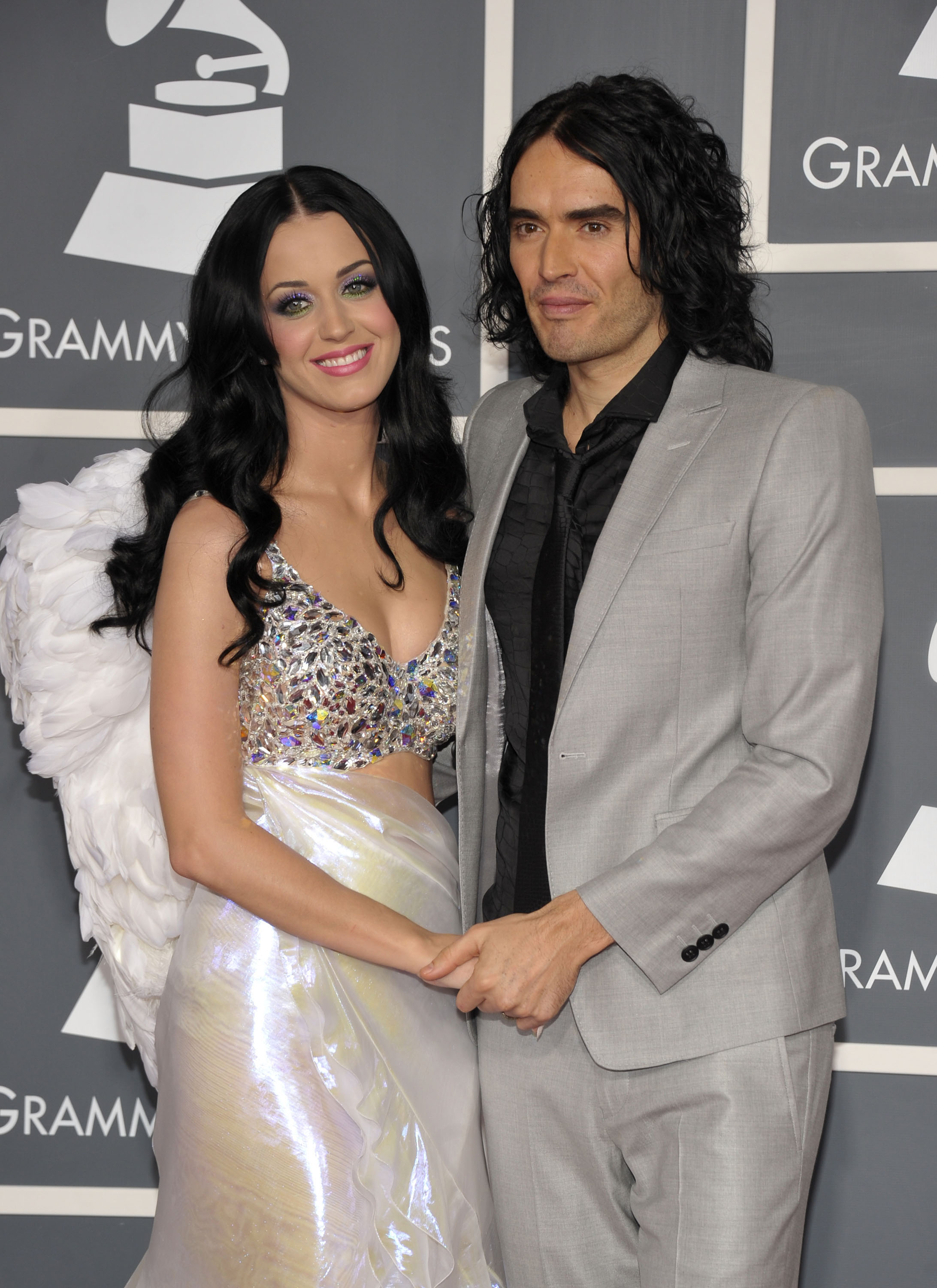 Closeup of Katy Perry and Russell Brand holding hands on the Grammys red carpet