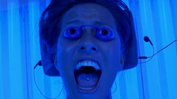 a woman screaming in a tanning bed