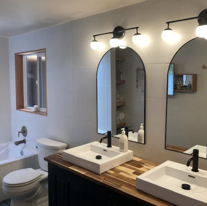 A reviewer&#x27;s arched bathroom mirror