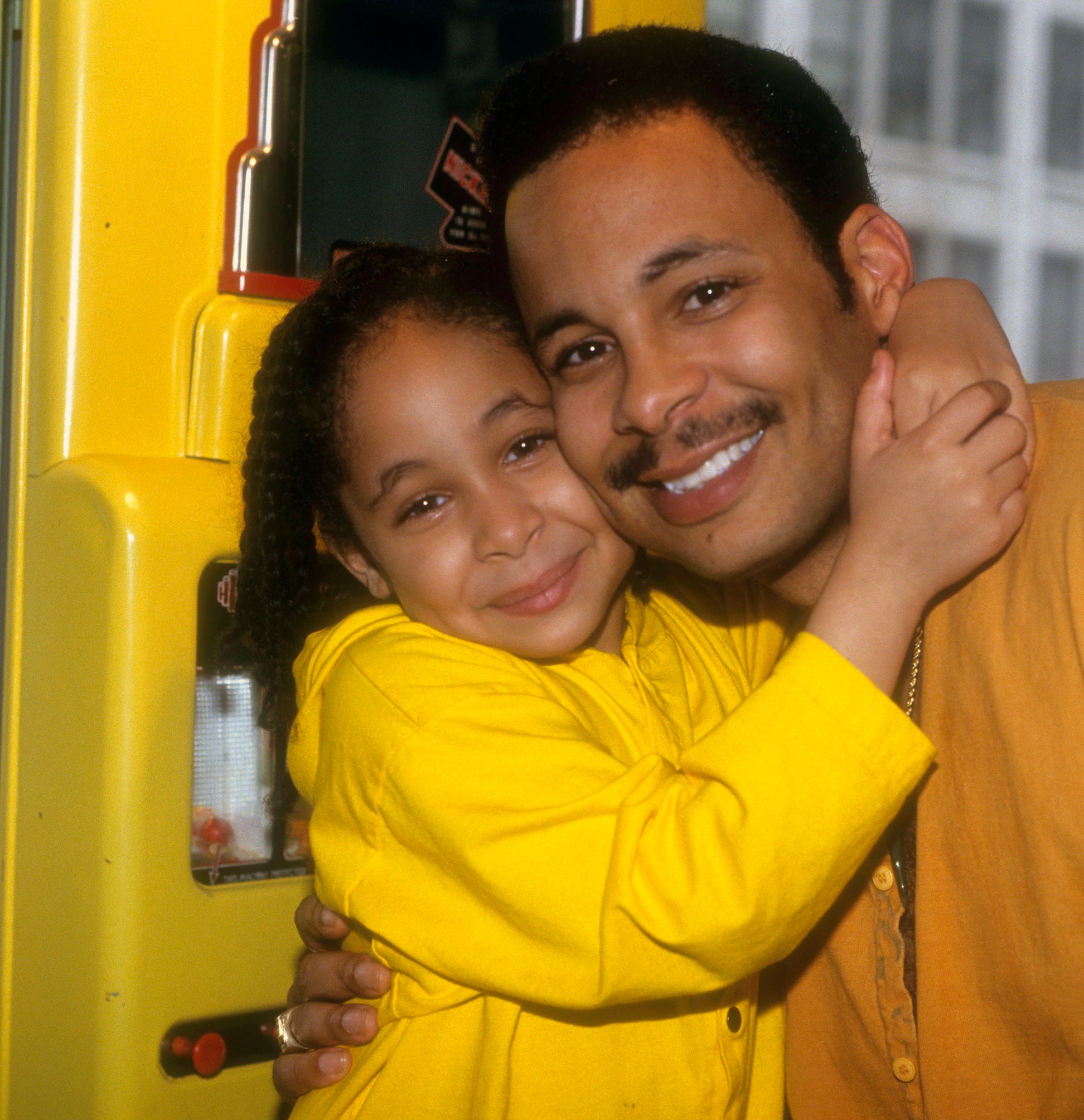 Close-up of Raven-Symoné as a child and her dad embracing