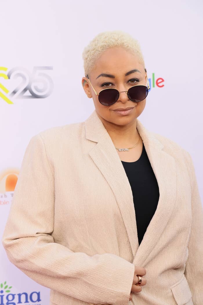 Close-up of Raven-Symoné at a media event in sunglasses and a suit jacket