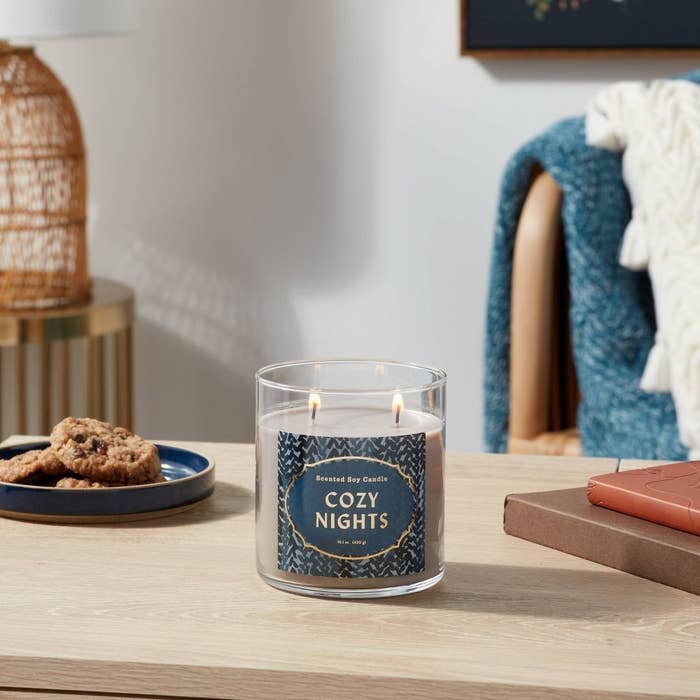 The Cozy Nights candle on a table top with decor
