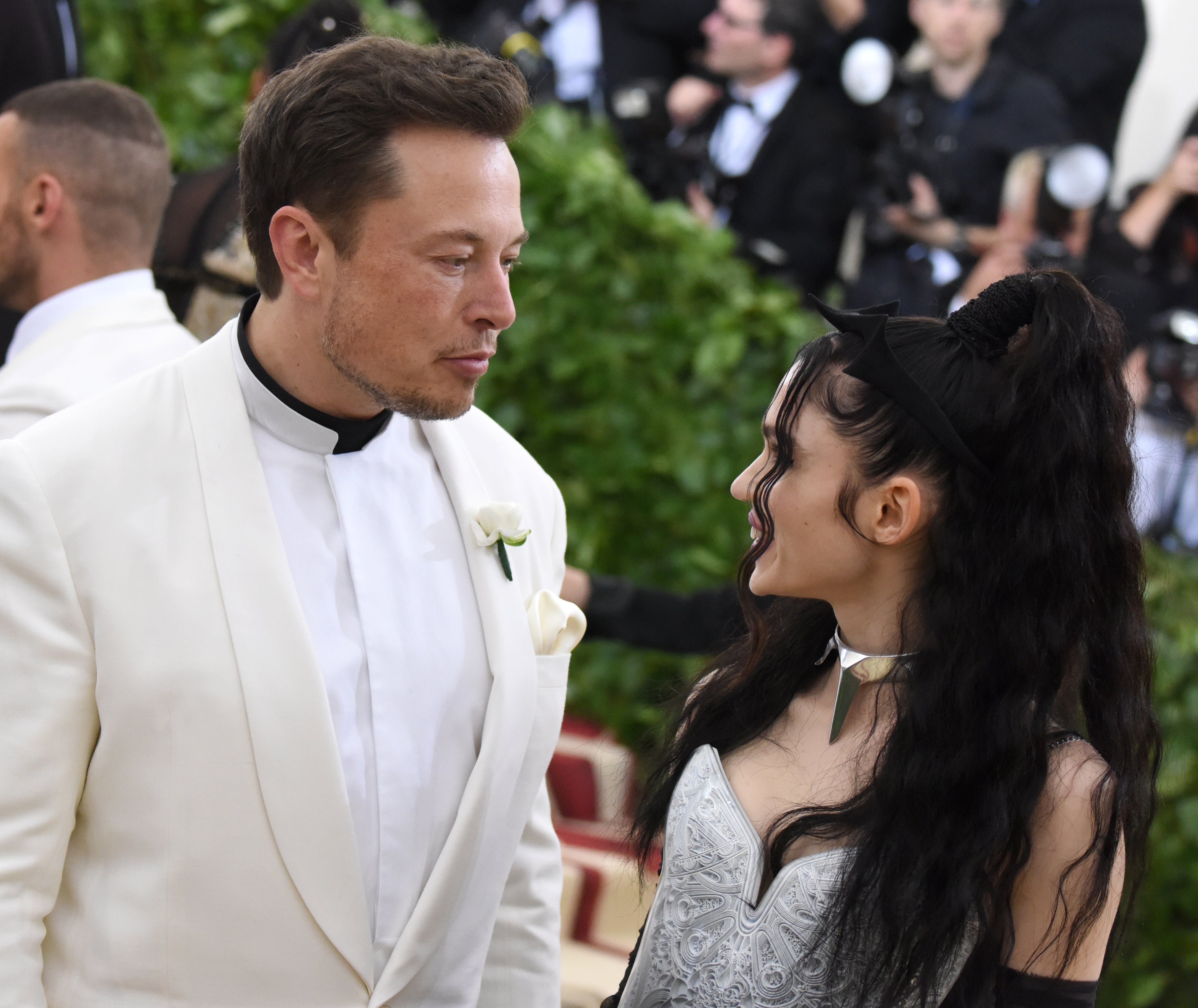 The former couple smiling at each other on the red carpet