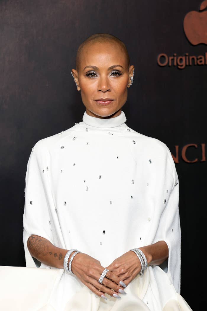 A closeup of Jada Pinkett-Smith on the red carpet with a bald head