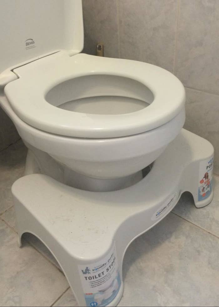 reviewer&#x27;s squatty potty in front of a toilet
