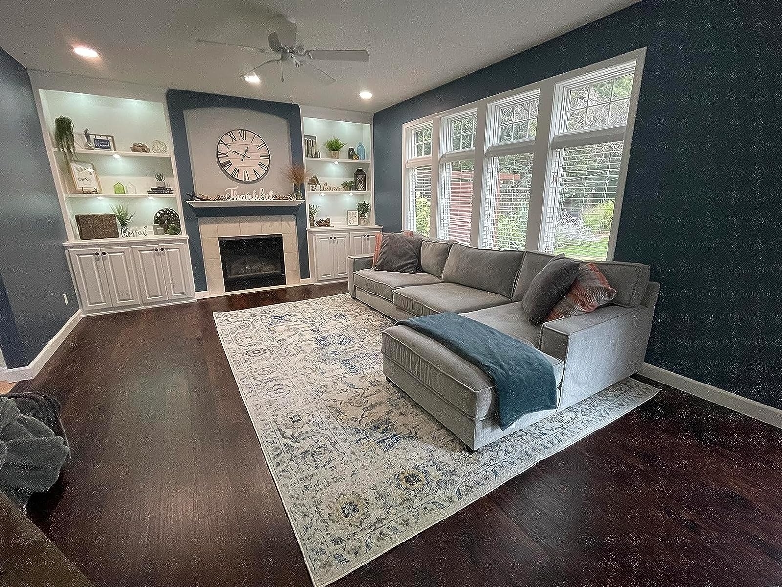 Reviewer image of the rug under a gray sectional in a family room