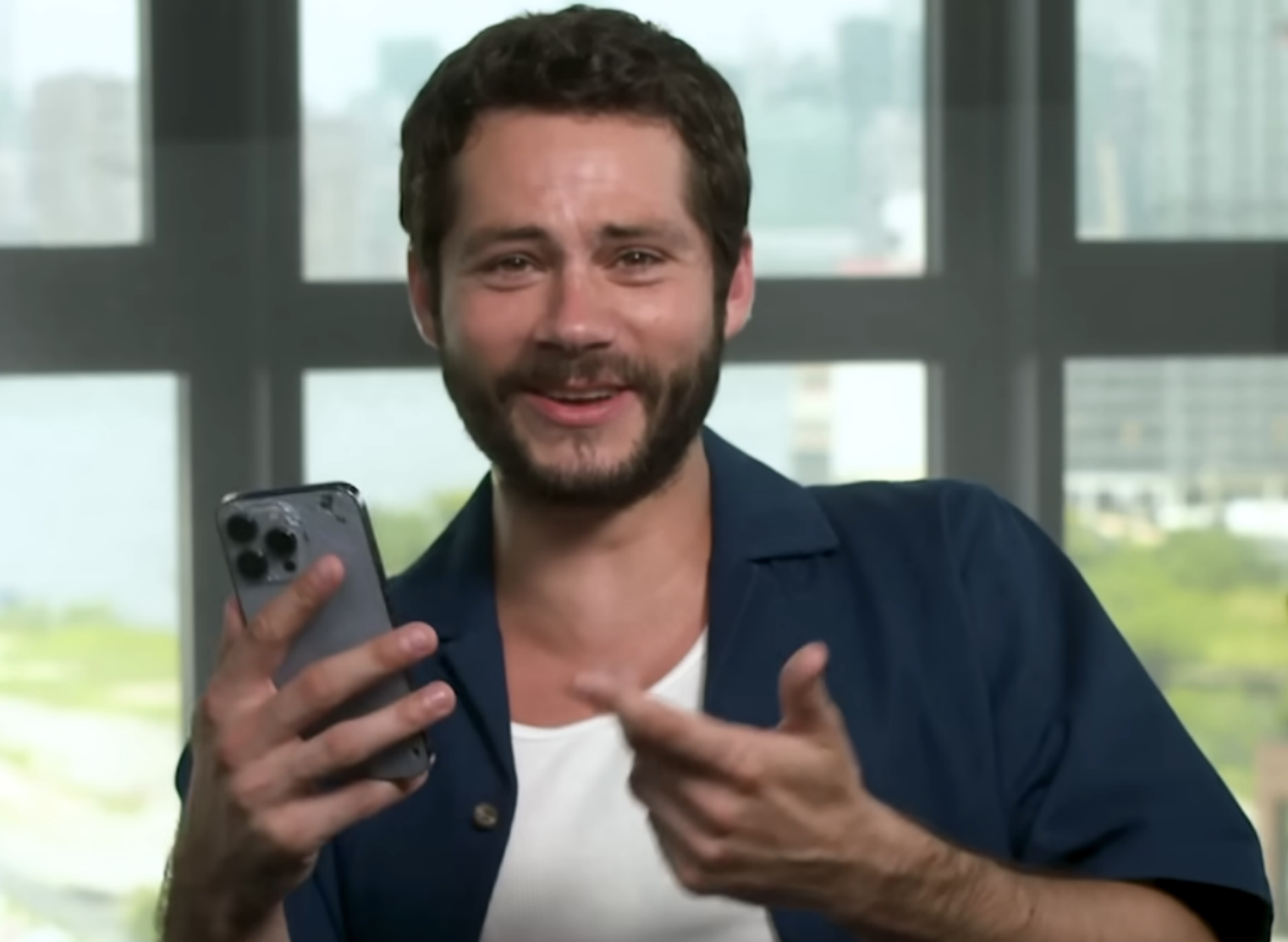 Dylan O&#x27;Brien cry-laughing at something on his phone