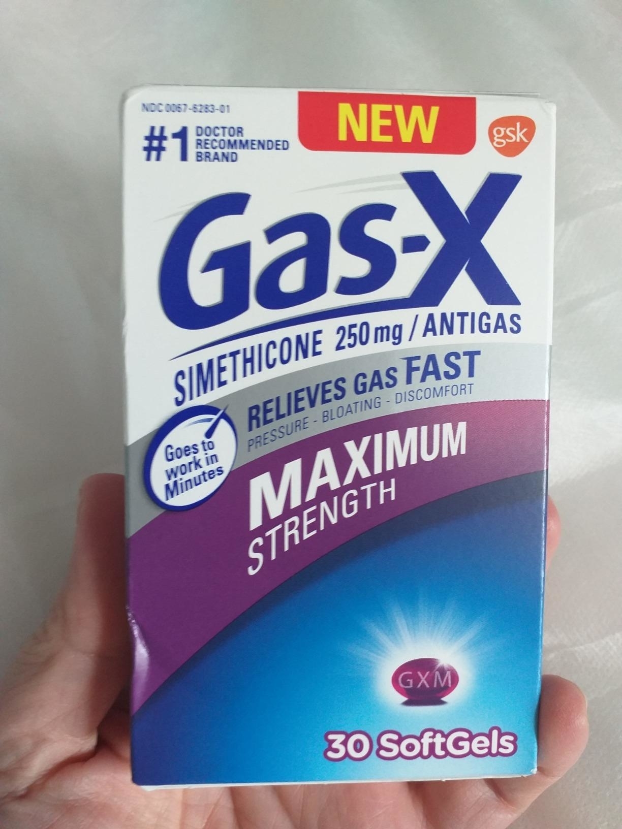 reviewer holding box of 30 soft gels of gas-x