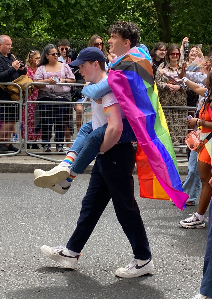 kit carrying joe on his back during the pride parade