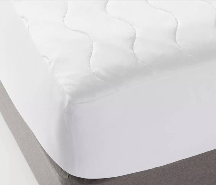 White quilted mattress pad on a mattress