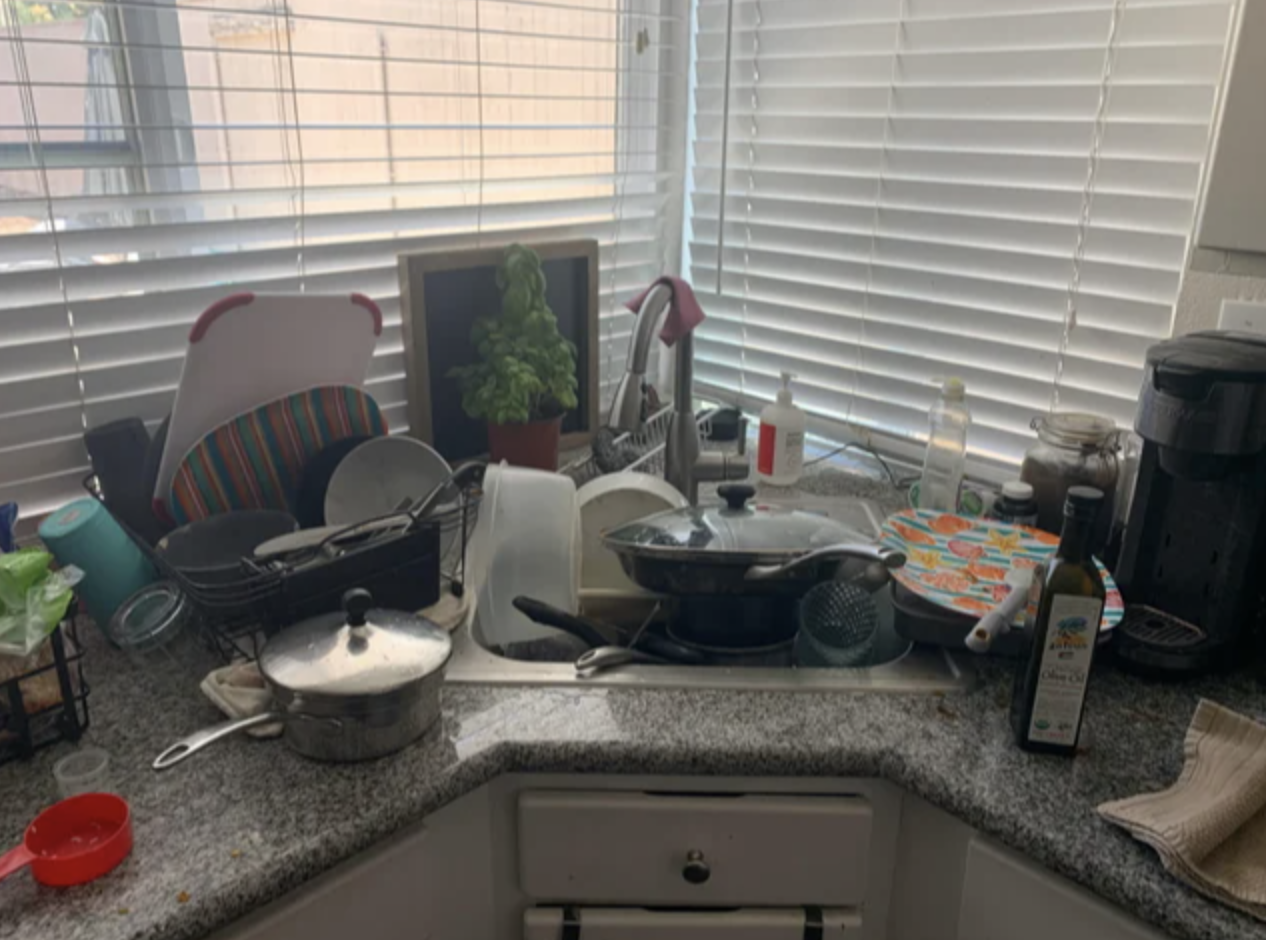 kitchen sink overflowing with dishes
