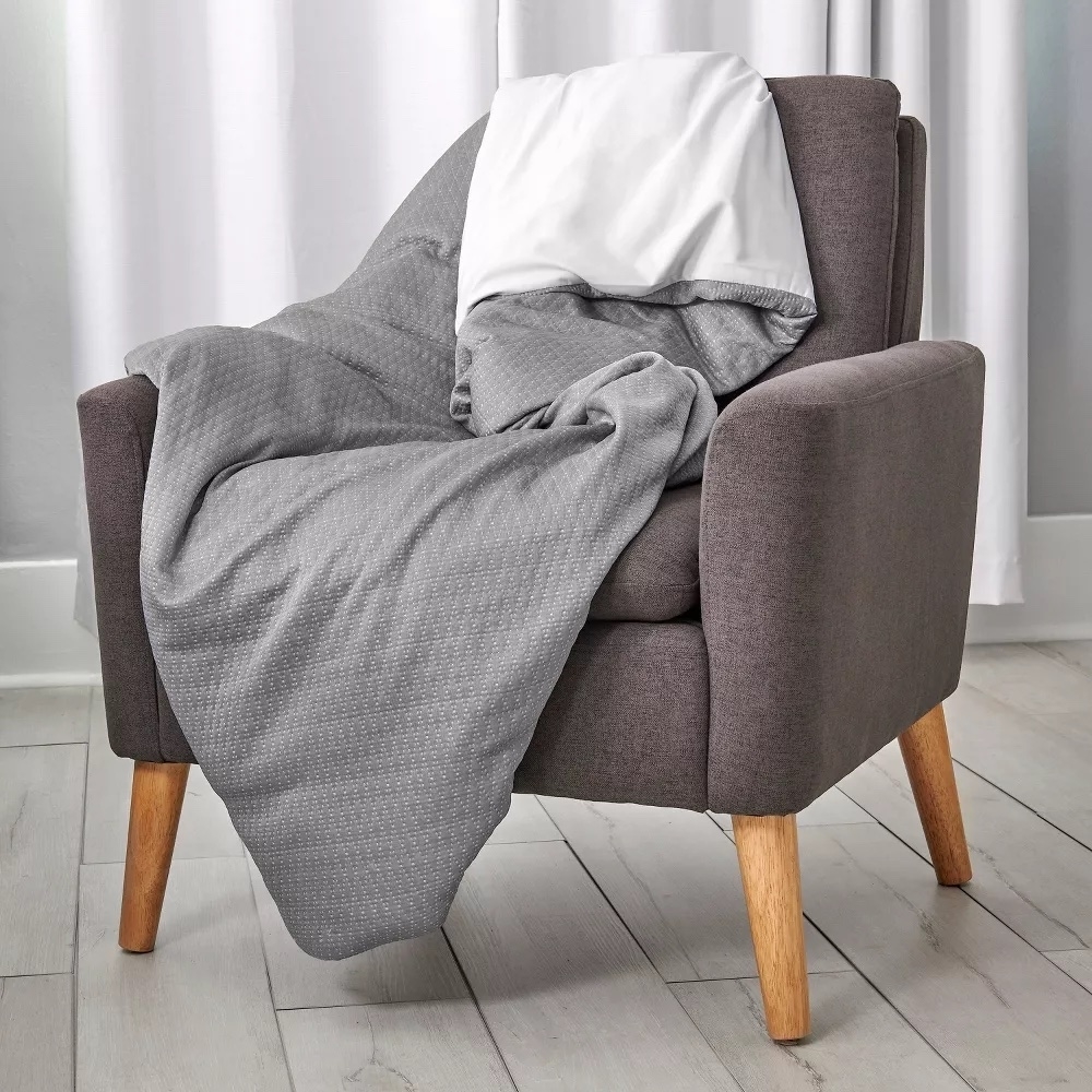 Gray cooling blanket on a gray armchair