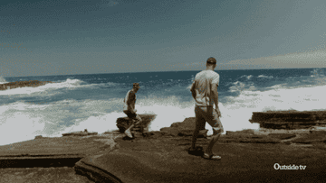 Men running away from the ocean