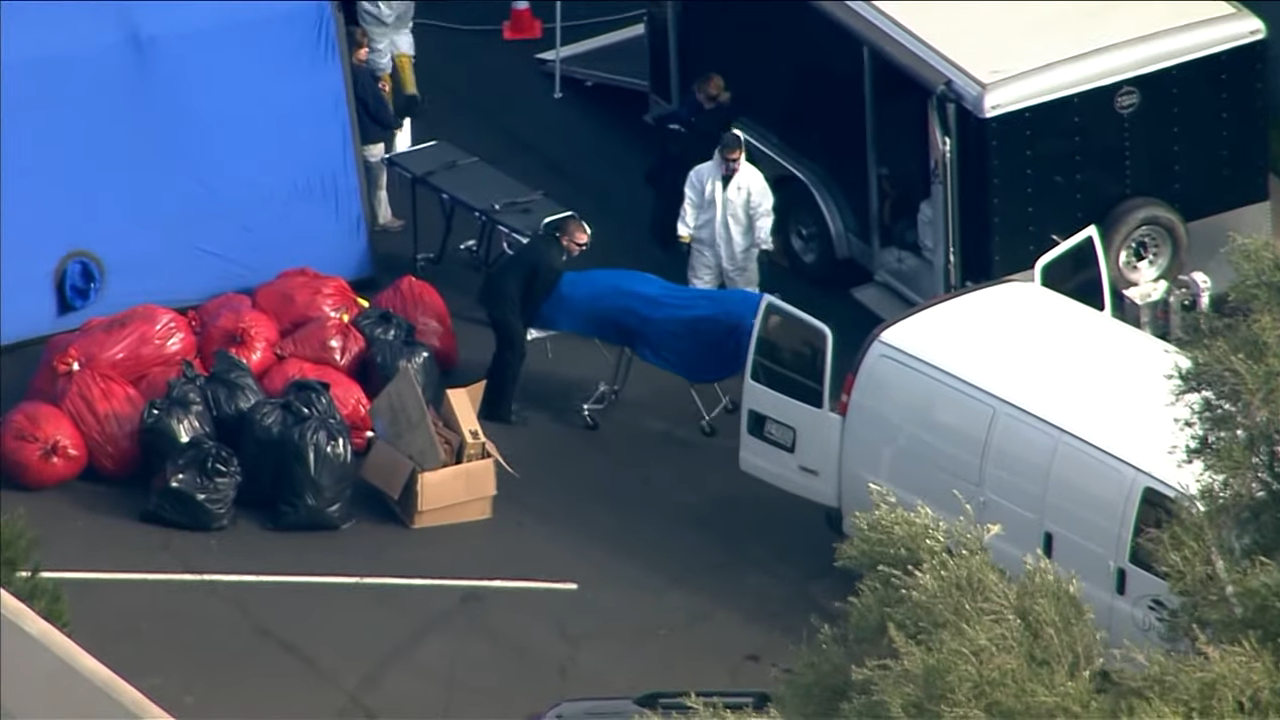 A body being loaded into a van