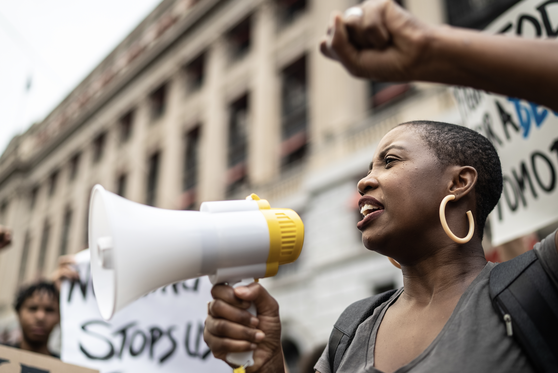 protestor speaking in a microphone
