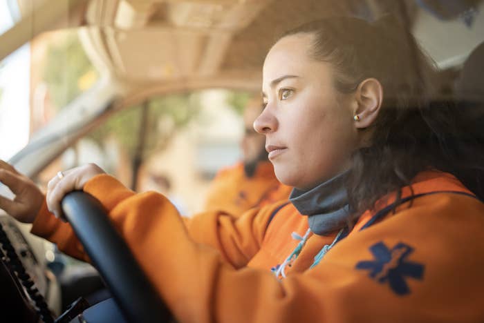 female EMT worker driving
