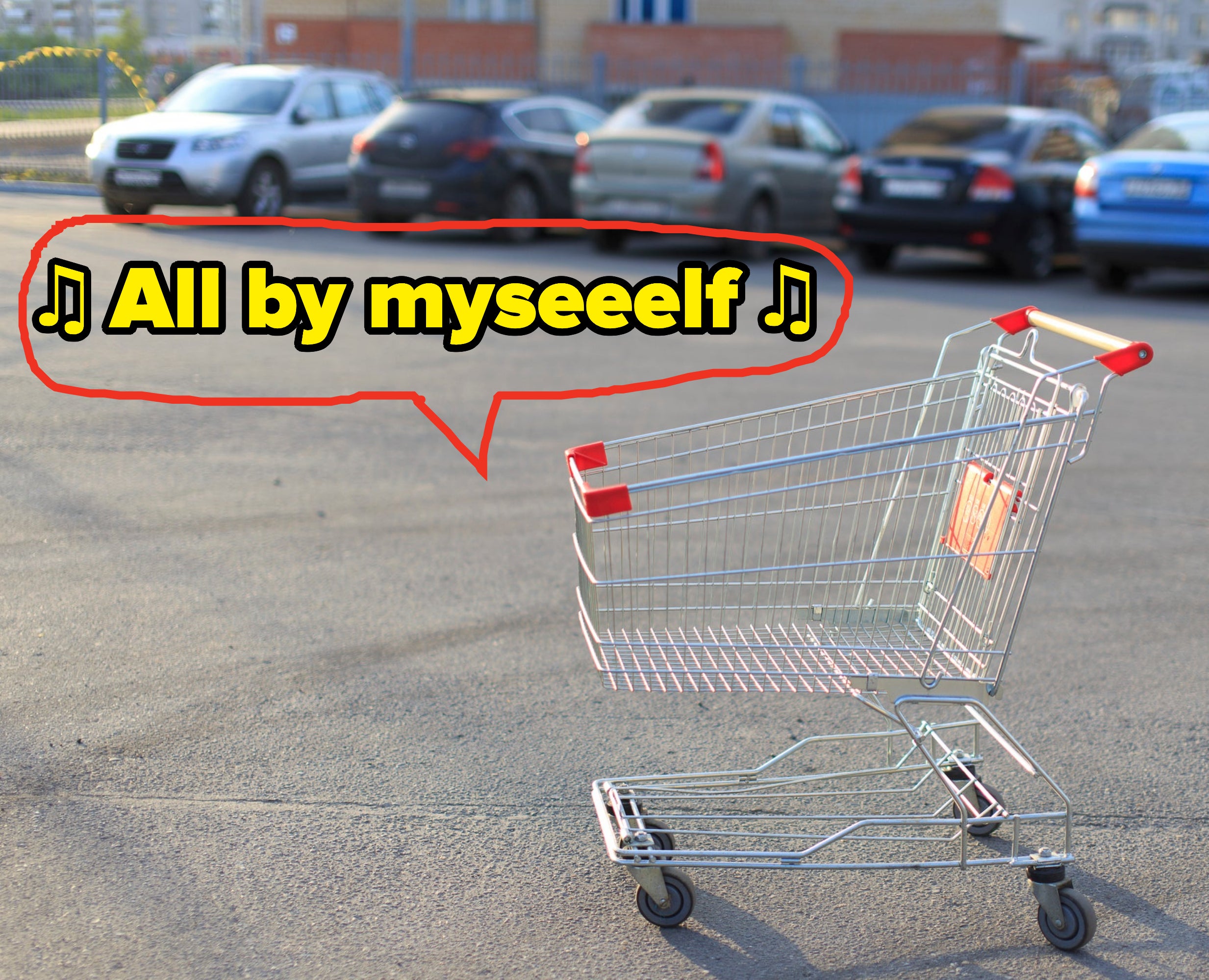 A shopping cart in the middle of a parking lot