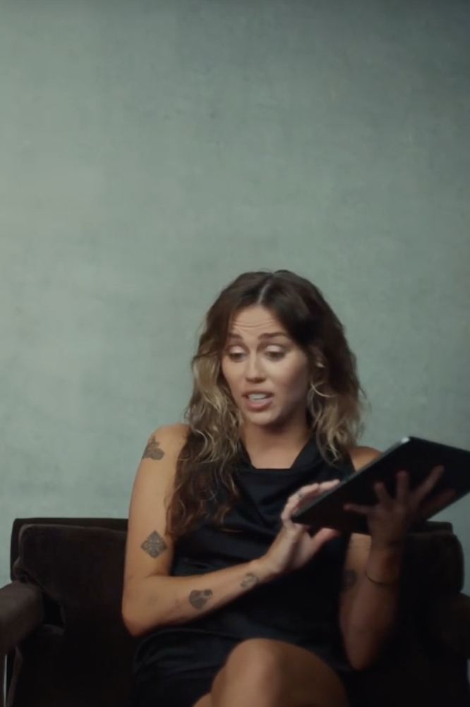 miley holding a tablet and talking into the camera