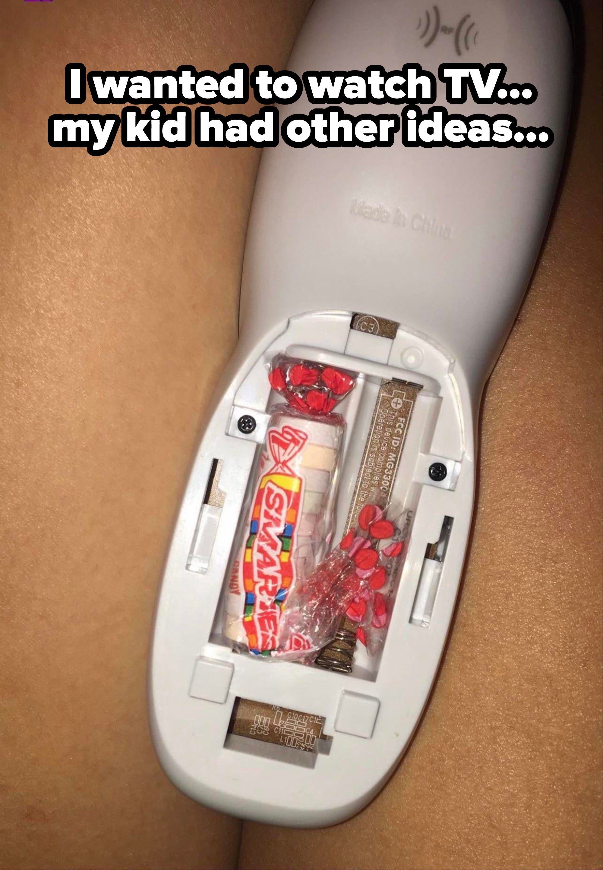 Smarties candies and candy wrapper where remote control batteries should be