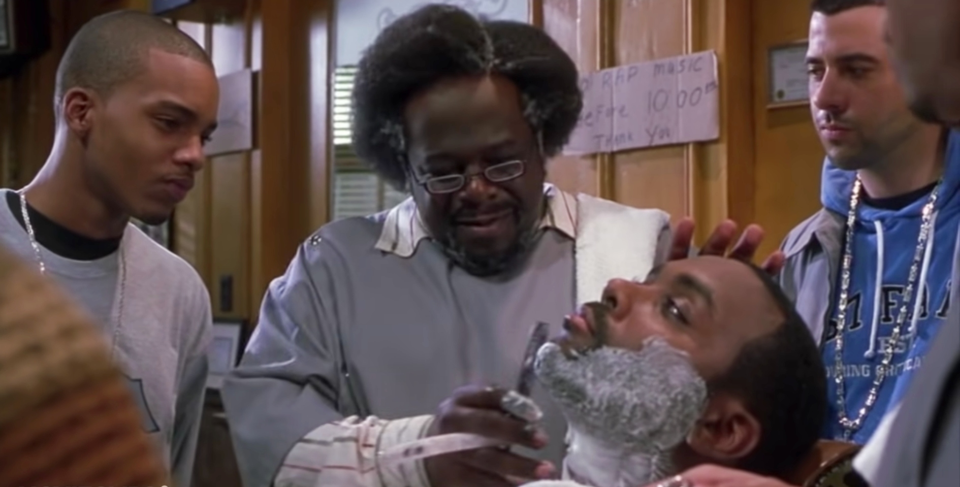 Characters from the movie &quot;Barbershop&quot; are watching as Cedric the Entertainer, who plays Eddie, is shaving a customer