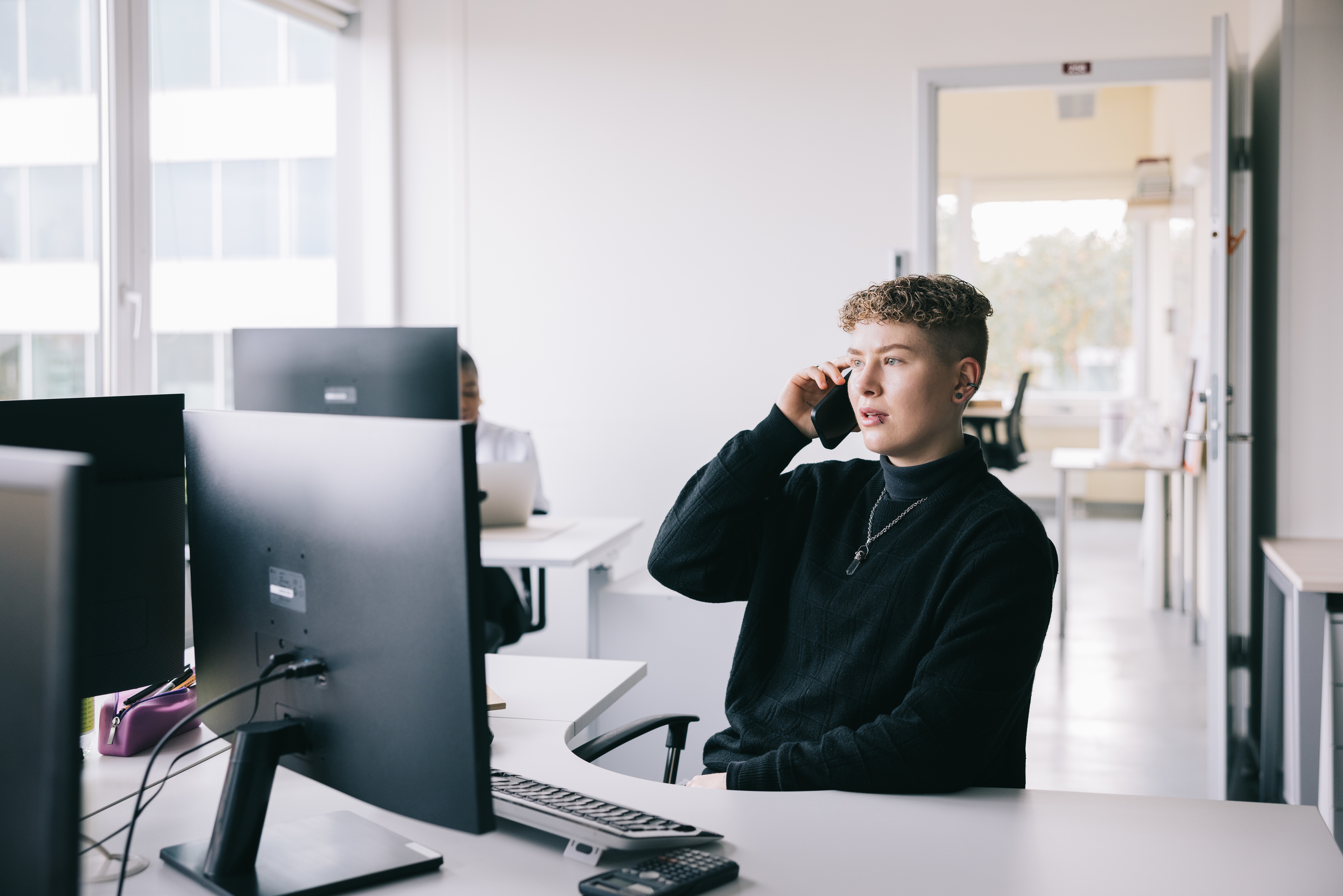 androgynous person working in an office