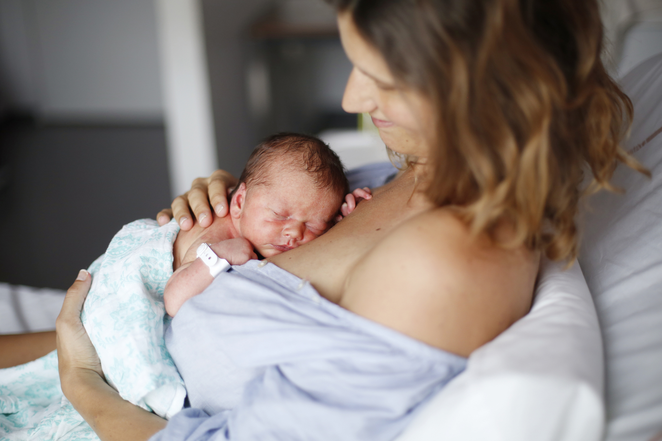 A woman in the hospital holding her newborn