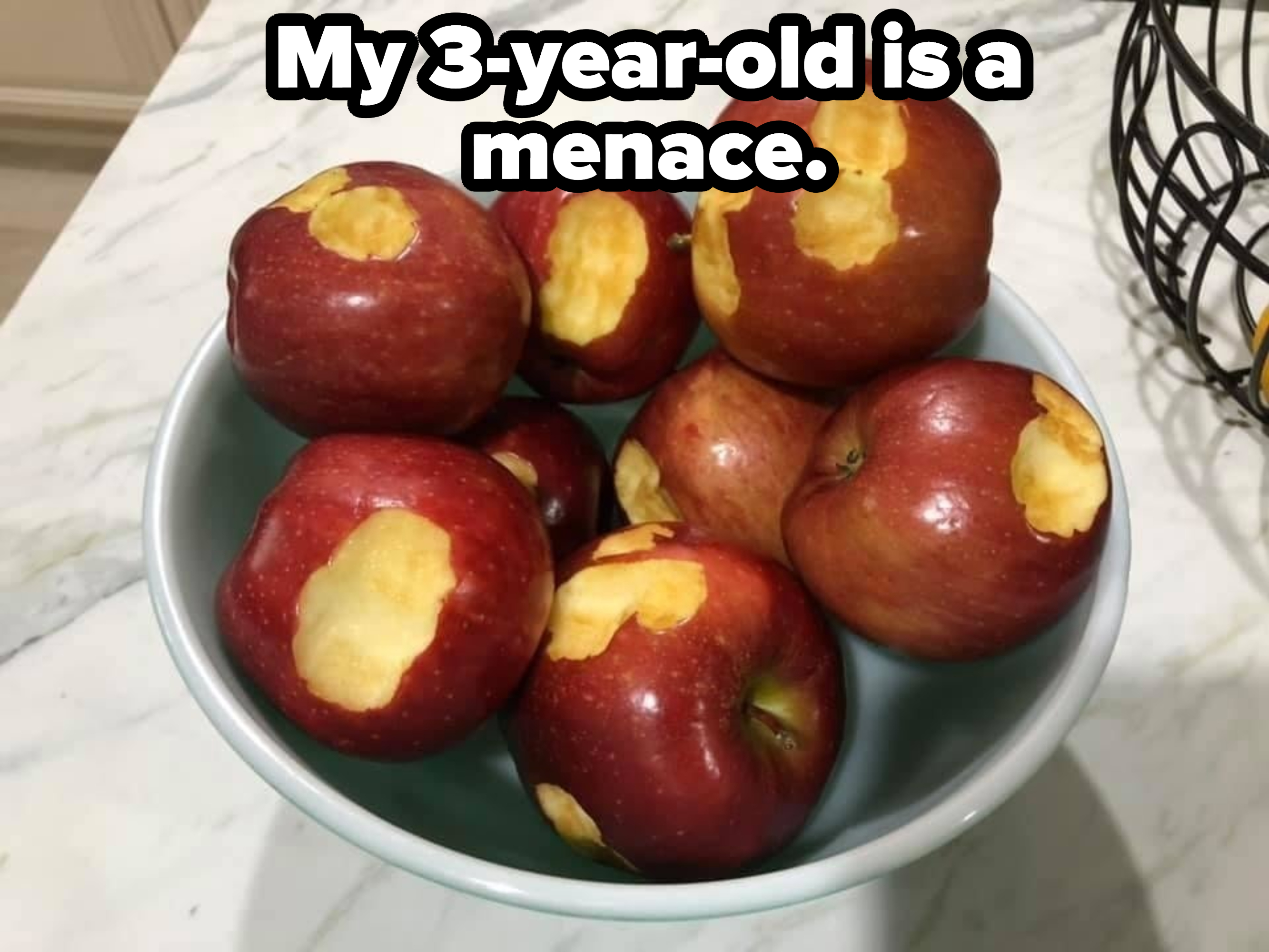 A bowl of apples, each with a bite in it, with the caption &quot;My 3-year-old is a menace&quot;