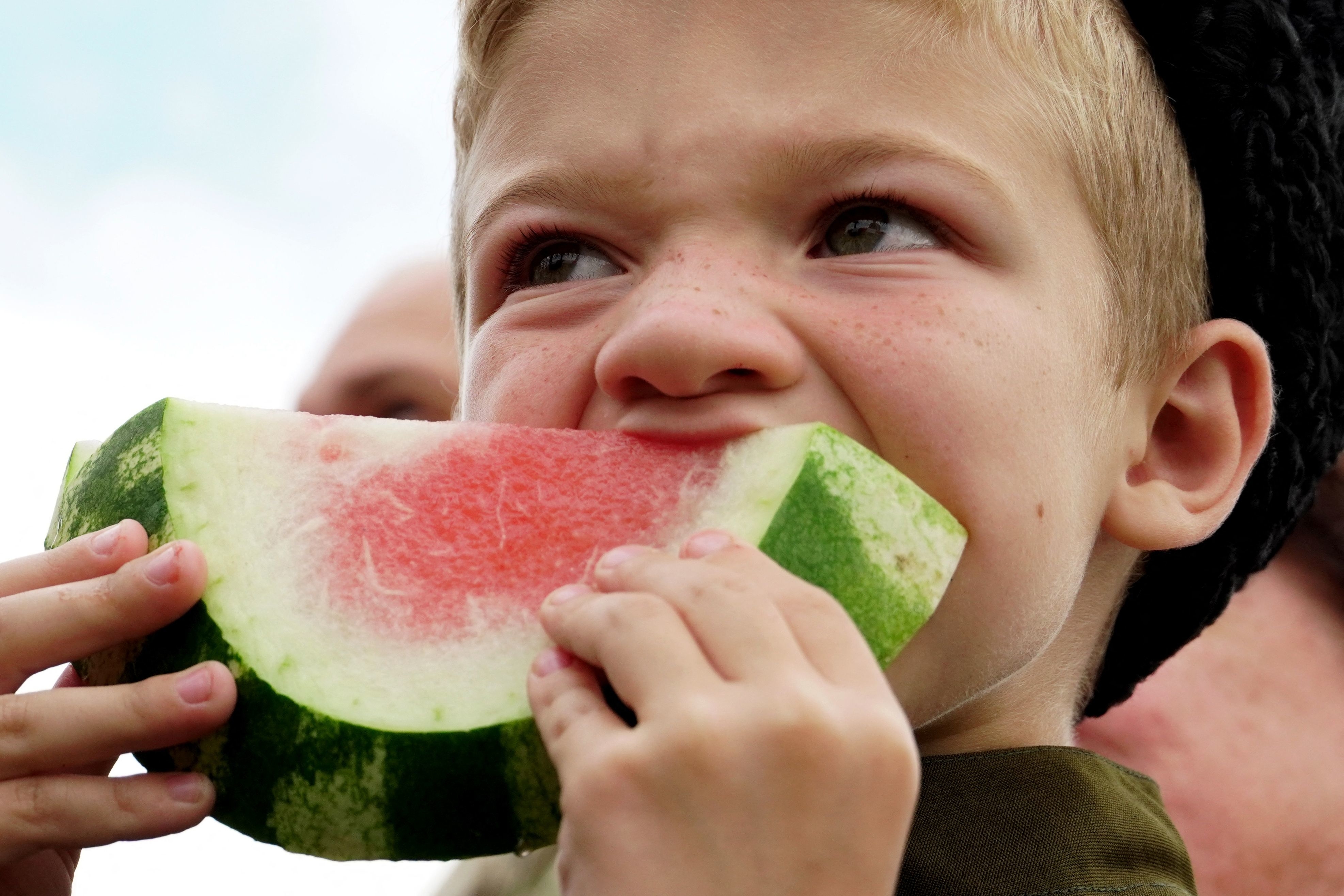 kid eating a watermelon slice