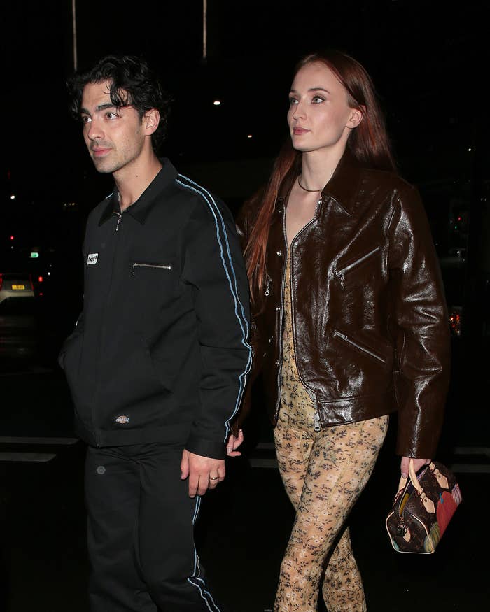 Joe Jonas and Sophie Turner walking side by side outside at night