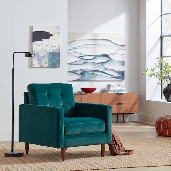 a teal accent chair in a living room
