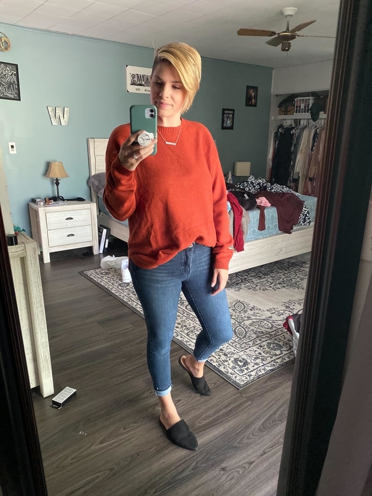 reviewer in red crewneck sweater