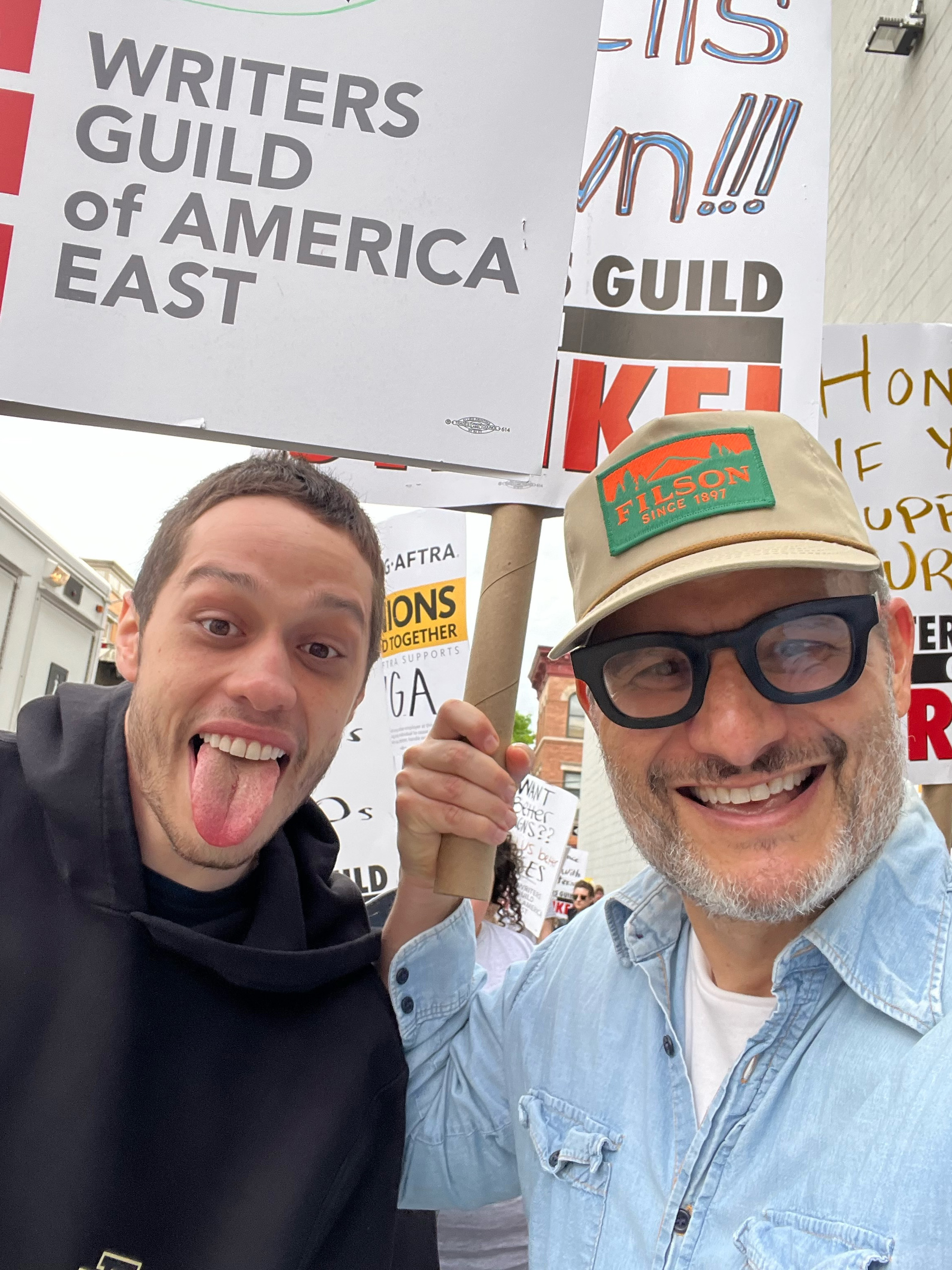 A close-up of Pete Davidson and a writer on the picket line