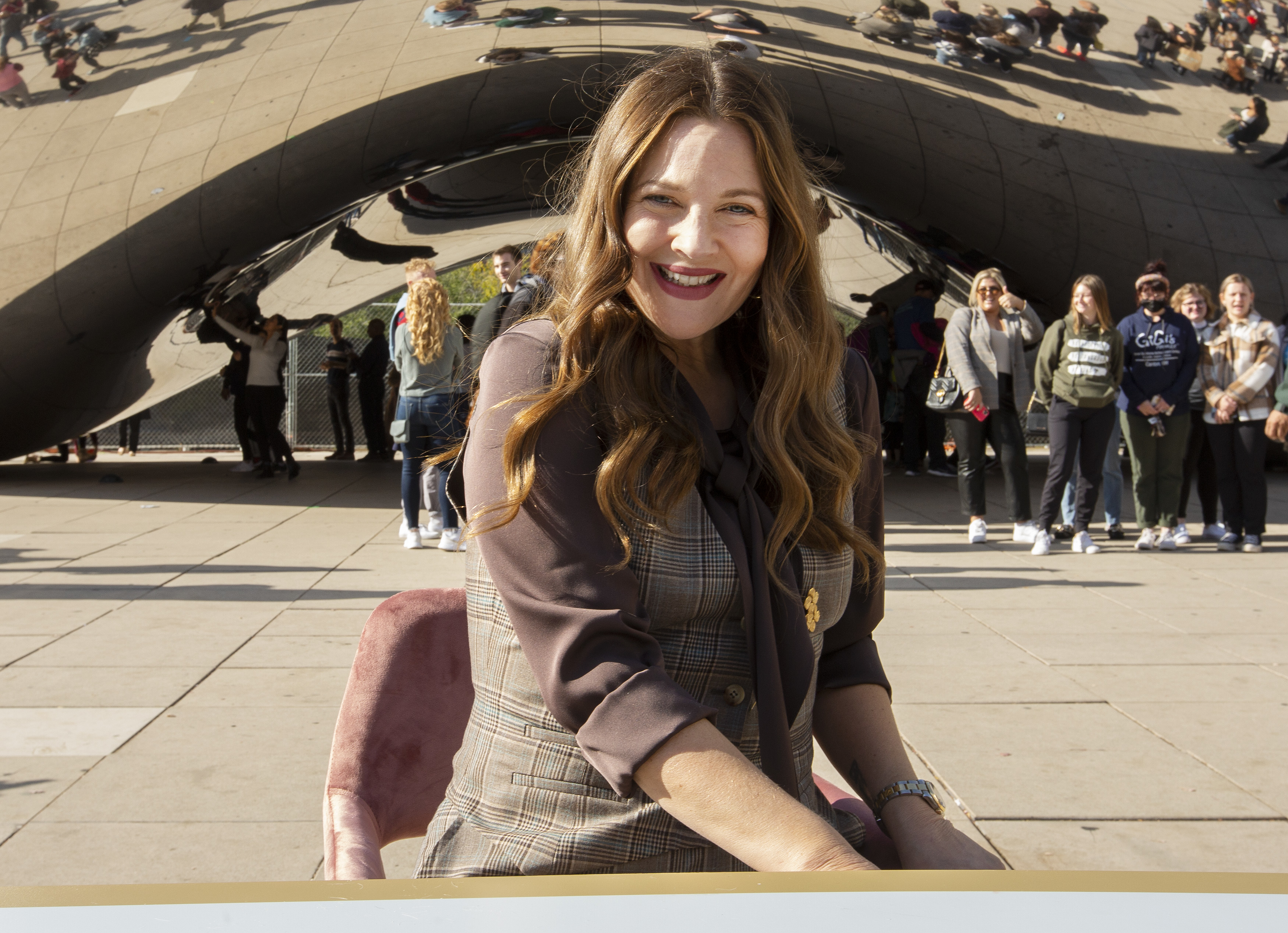 A close-up of Drew sitting outside and smiling