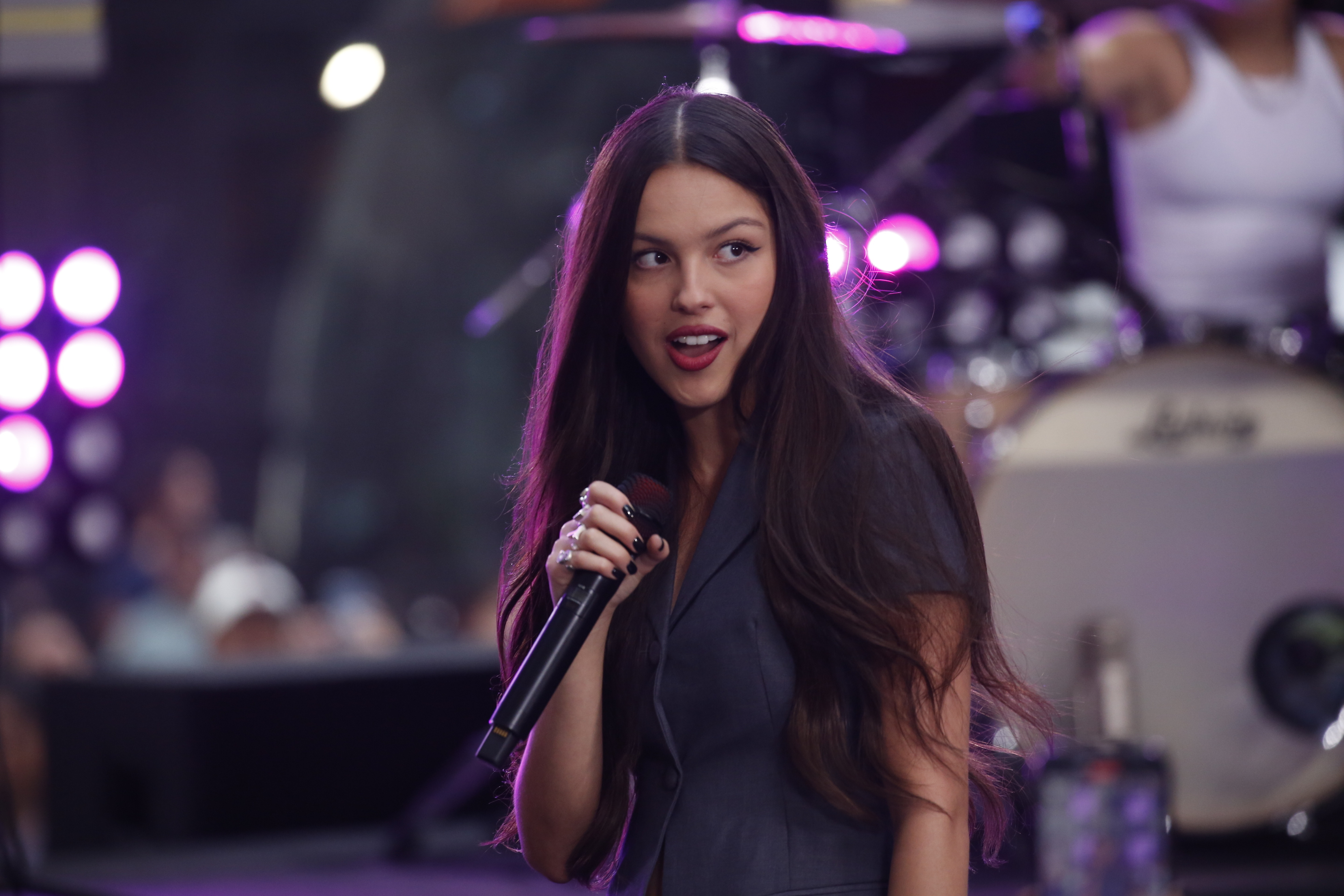 A close-up of Olivia singing