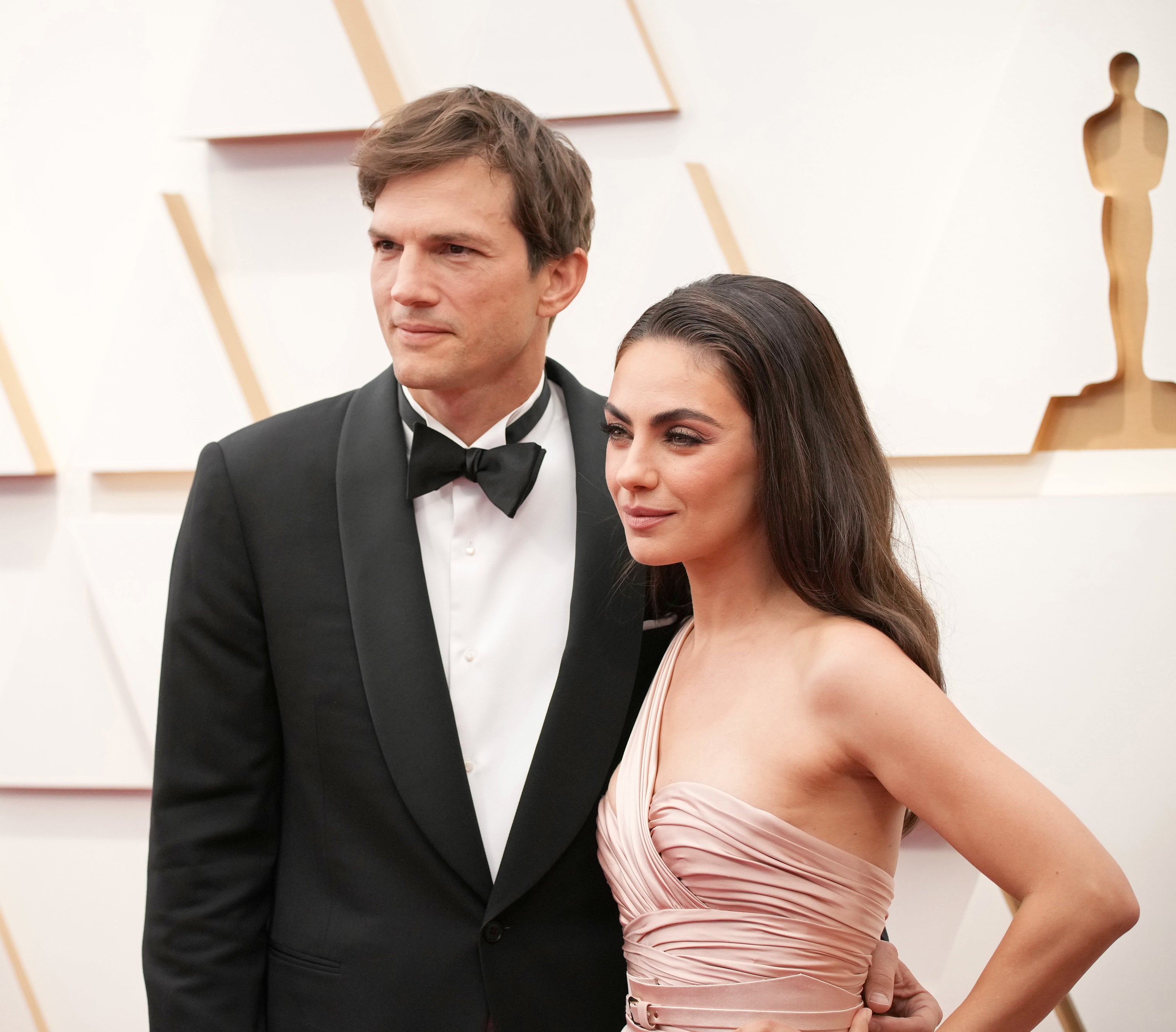 Close-up of Ashton and Mila at a media event