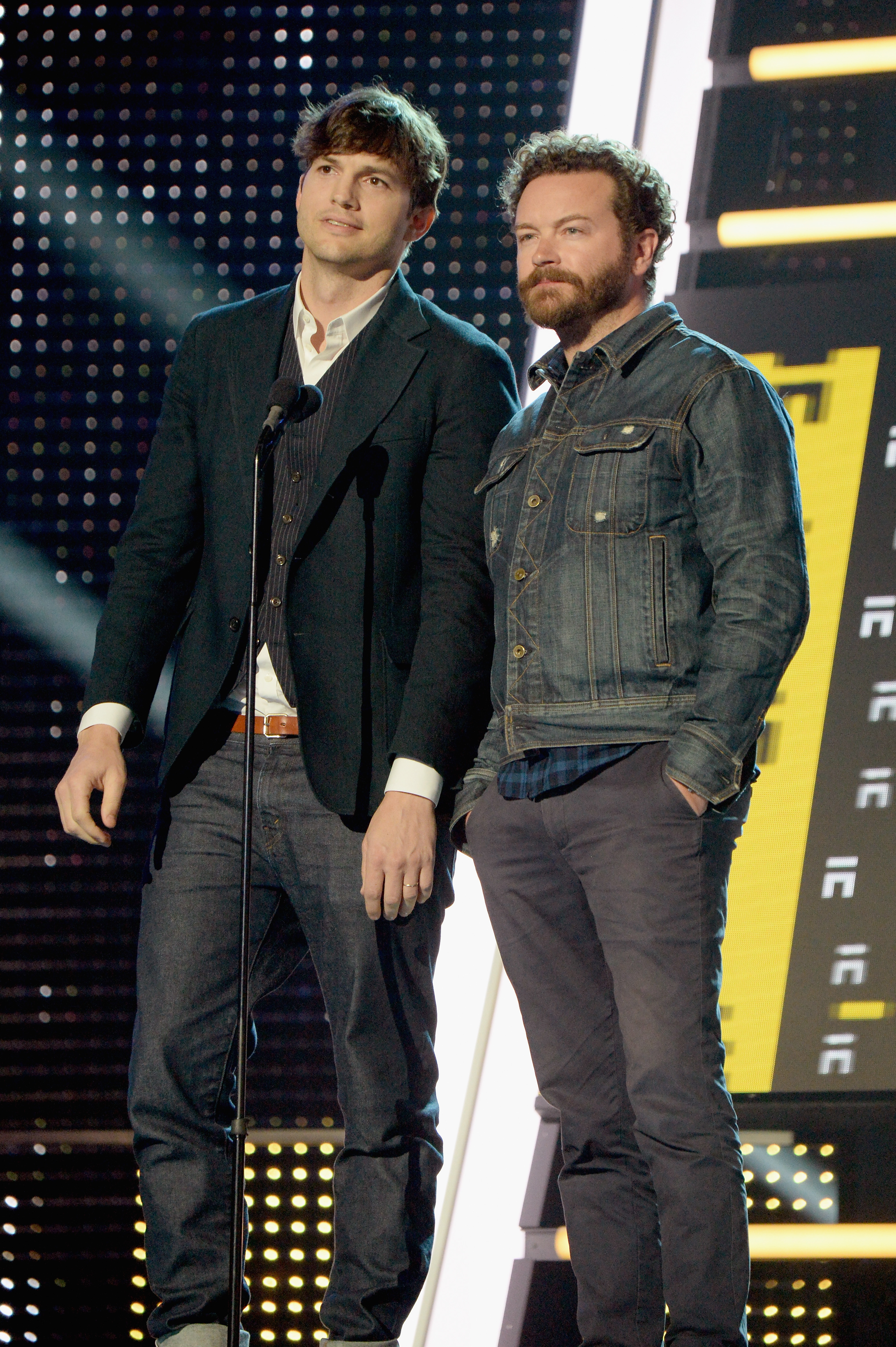 Close-up of Ashton and Danny standing onstage together