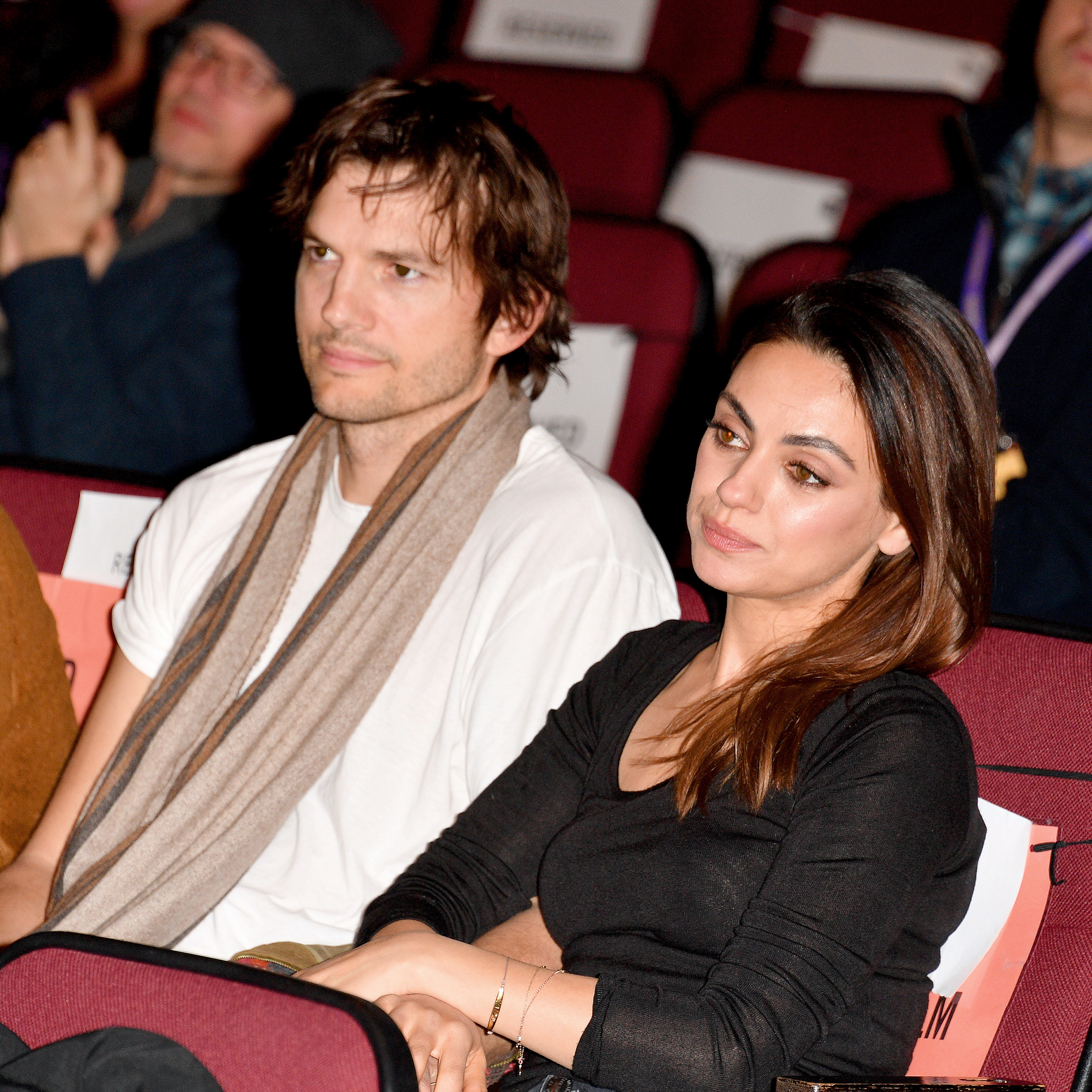 Close-up of Ashton and Mila sitting together