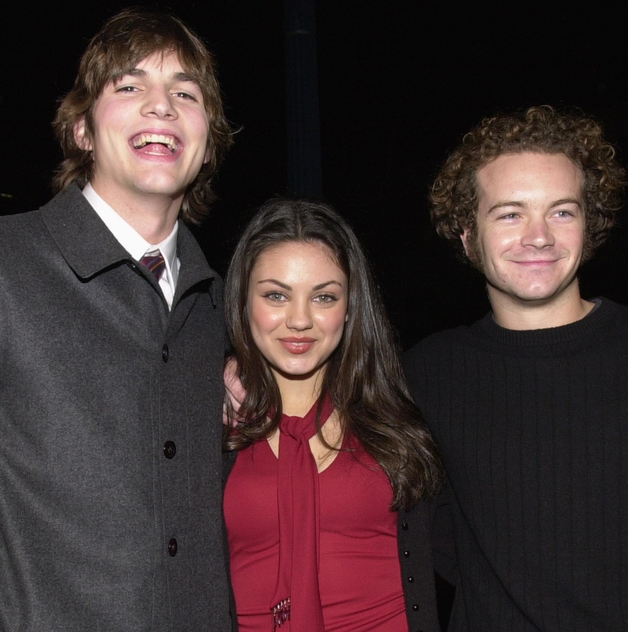 Close-up of Ashton, Mila, and Danny smiling together