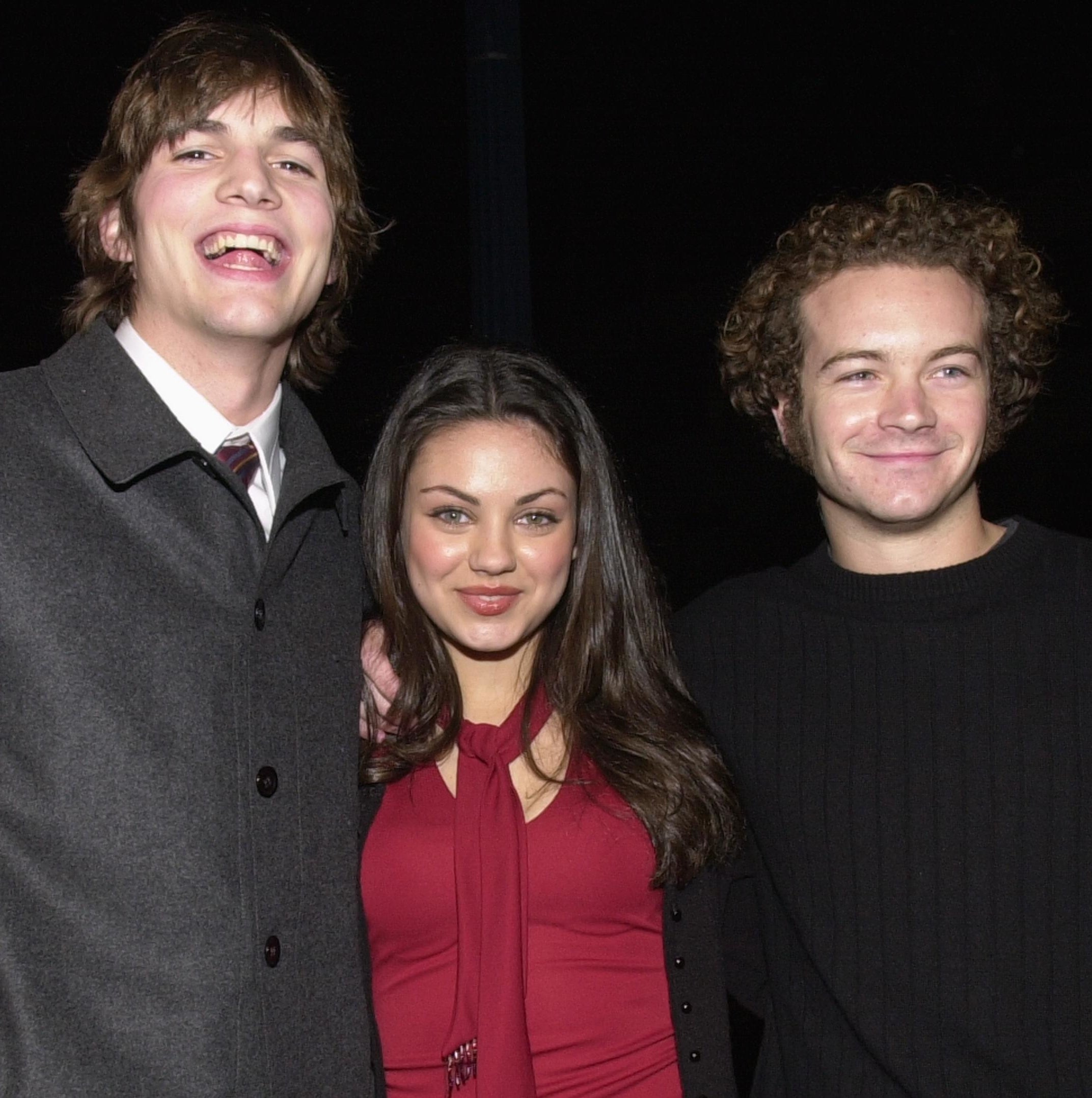 Close-up of Ashton, Mila, and Danny smiling together