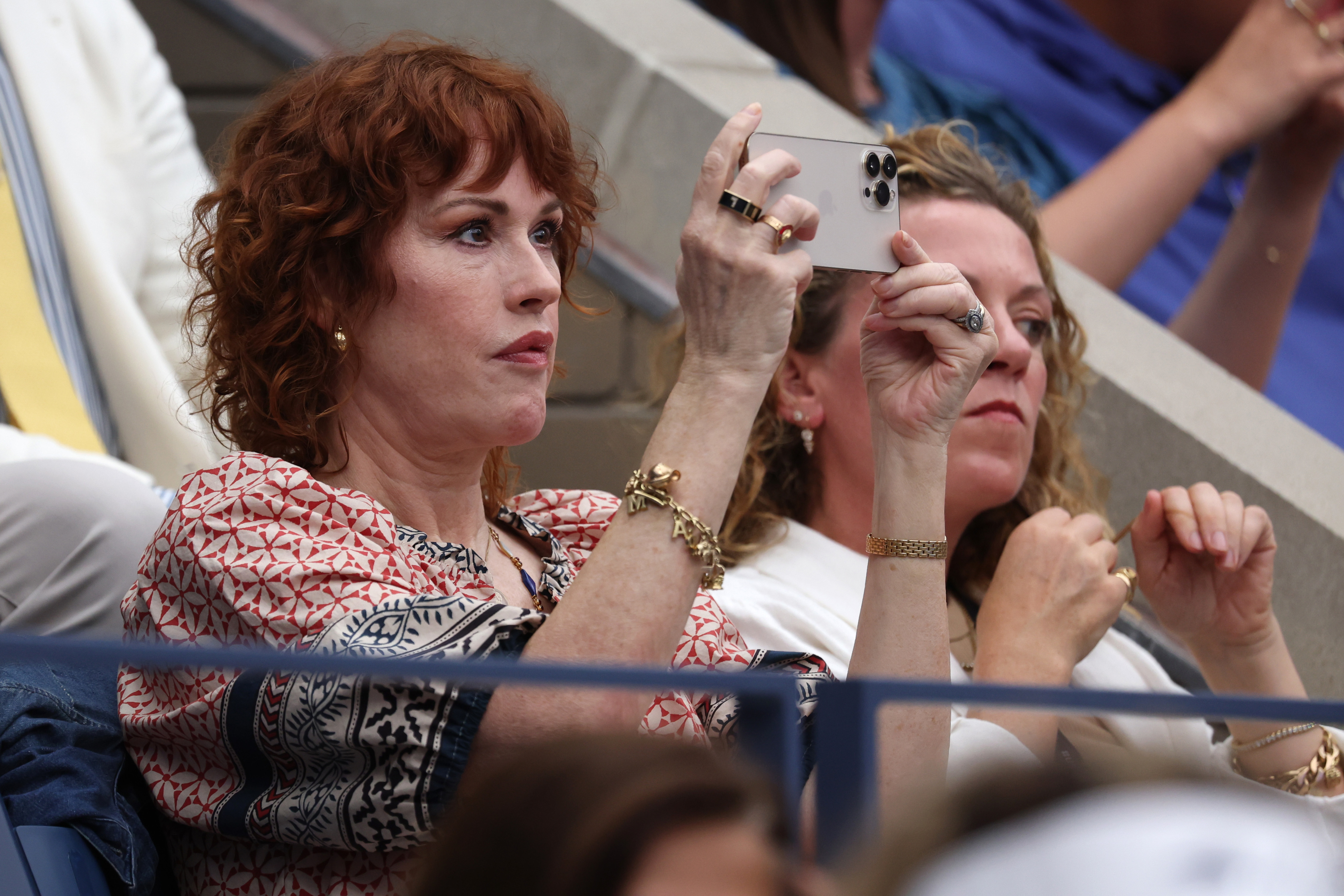 Molly Ringwald taking a photo of the match